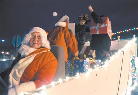 Jack Collins, a.k.a. Santa Claus, sits patiently behind the wheel for the parade to begin while “O’Leary’s Old Ladies” prepare for their gala ride down Main Street.