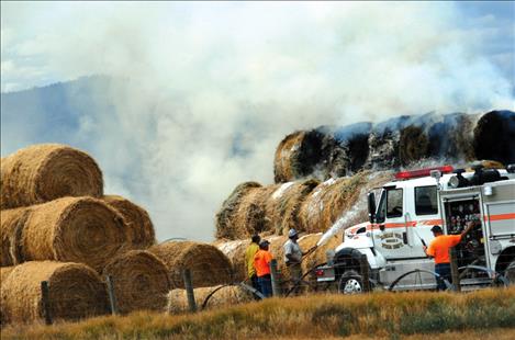 Ronan Fire Department helps douse a hay fire caused by lightning Wednesday after a storm moved through the area.