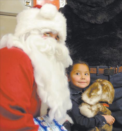 Jordan Singer shares a moment with Santa during a visit from Ronan firefighters before Christmas.