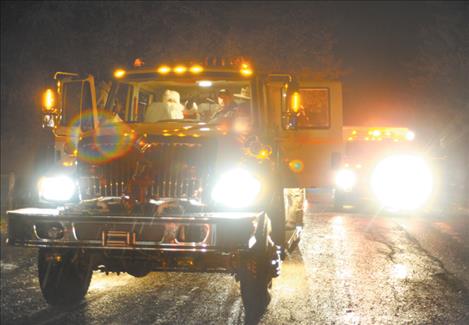 For the annual Ronan Firemen's Christmas, a fire truck doubled as Santa's sleigh when firefighters escorted the jolly fellow to deliver gifts to local children. 