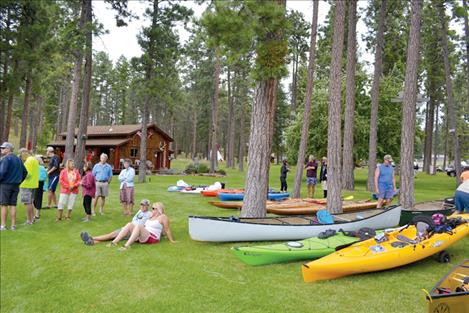 Paddlers relax after completing the course for the inaugural Flathead Laker Poker Paddle July 12.