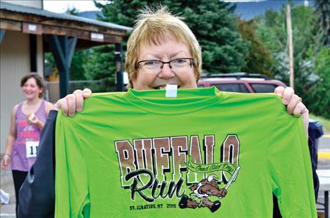 Maggie Roddam  from the  St. Luke team displays this year's race T-shirt. 