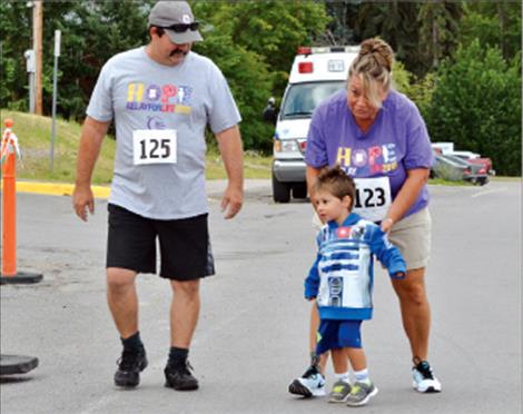 Crue Cordier, 2, learns how to finish a race with direction from his grandparents.