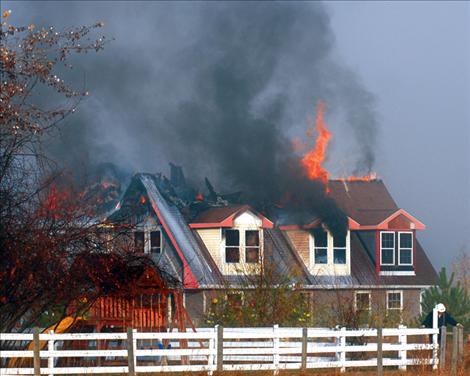 Flames shoot from the roof of a house in Valley View. The structure was a complete loss although the garage did not burn. 