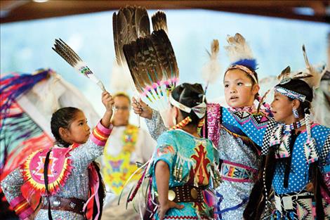 Four jingle dancers compete in the team dance. 