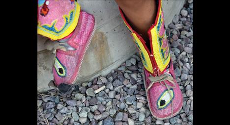 Tiny moccasins take a break from dancing.