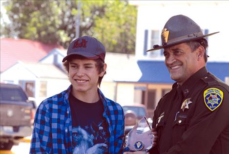 Shayne Pierre receives his Montana Highway Patrol Colonel’s Award for Meritorious Service from Montana Highway Patrol Major Steve Lavin.