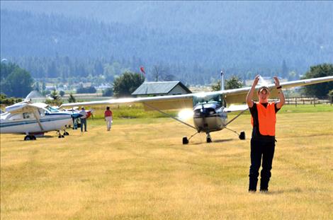 Jessie Girsch,15, directs airport traffic.