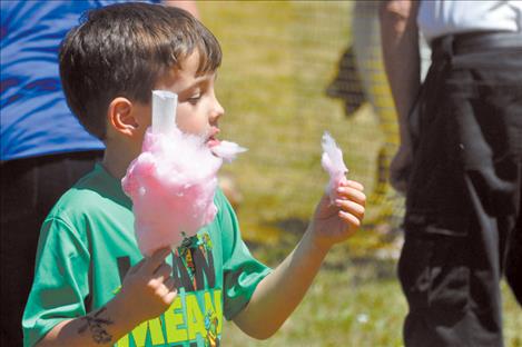 Matthew Broughton chows down on some cotton candy.