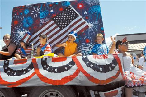  Participants in the Mission Mountain Pageant wave in the 33rd annual Good Old Days parade. 