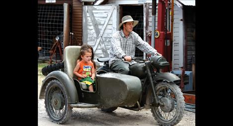 A ride in a sidecar around the Miracle of America Museum grounds brings a worried look to a young man’s face. 