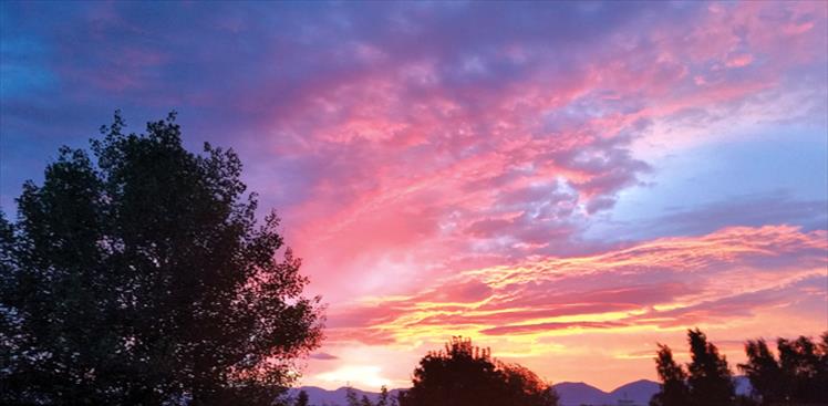Purple mountains are the backdrop for a blazing sky as the Mission Valley awakens to a new day.