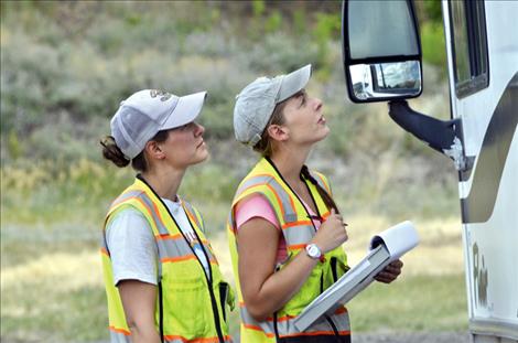 Inspectors Tabitha Espinoza and Jorri Dyer talk to a driver during an inspection.