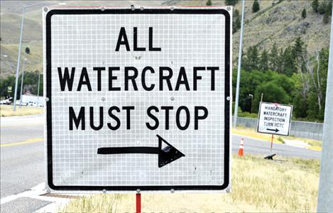 Signage on Hwy. 93 directs drivers hauling watercraft to stop for inspection.