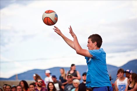 A teen shoots a 3-pointer during Hoopfest. 