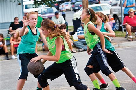 Young basketball players hit the pavement in 3-on-3 action.