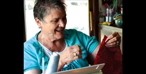 Sitting at her sewing machine near a window that faces north, Kay Krantz works on a quilting project. 