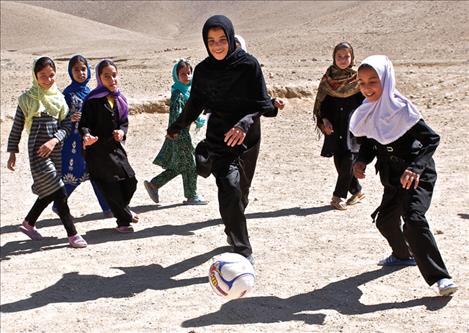 Afghan girls play soccer at one of the soccer fields developed by Trust in Education, a foundation started by philanthropist Budd MacKenzie.
