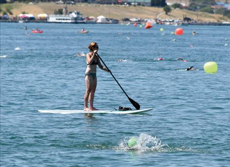 A paddleboarder helps mark the course at 2015 Water Daze in Polson Bay.