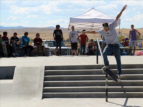  Contestants watch Skate Jam organizer Jesse Vargas slide down a rail at Saturday's event. Vargas placed first in the Rail competition. 