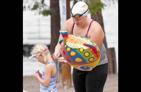 Von Jentzen helps a young Lake Monster with her balloon before the swim
