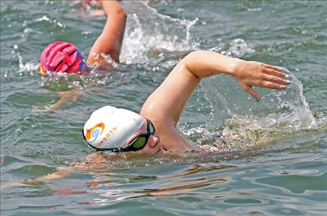Ultra-marathon swimmer and Enduring Waves Foundation founder Emily Von Jentzen, flanked by Mission Valley Aquatics director Ali Bronsdon, swims the length of Lake Mary Ronan Aug. 4 during her 30-60-90 charity swim project