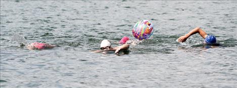 Members of the Lake Monsters swim team swim across Lake Mary Ronan Aug. 4 