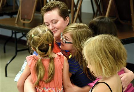 Kendra Mullison hugs a group of bug racers