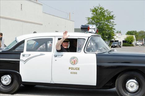 Ronan Police Chief Ken Weaver waves from an antique police car in the Pioneer Days parade. 