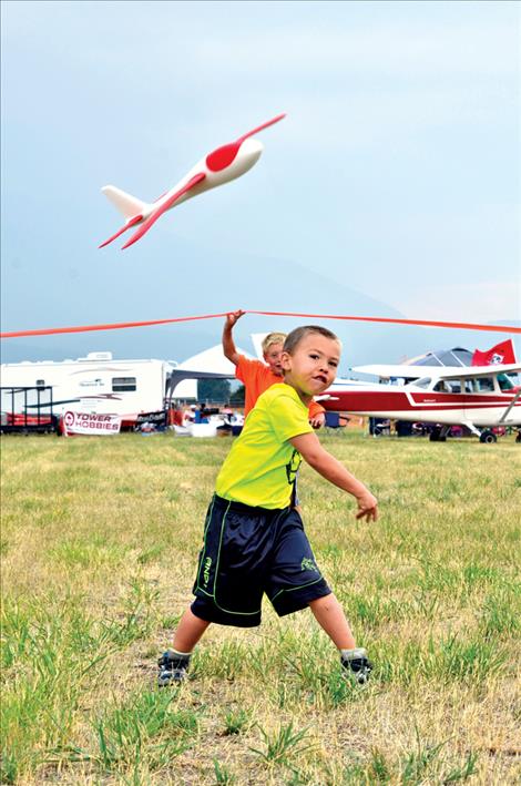 Keegan Williams-Powell, 5, flies a glider during the Wings for Wishes fundraising event Saturday, Aug. 15 at the St. Ignatius airport.