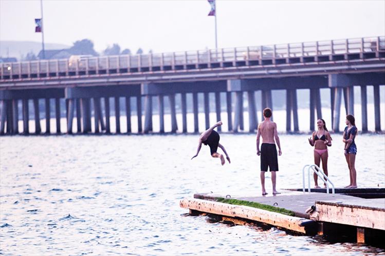 Despite smoky skies, swimmers enjoy the summer at Riverside Park.