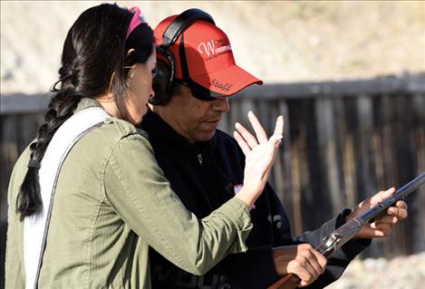 Berl Tiskus/Valley Journal  Miss Montana USA Tahnee Peppenger discusses guns with Carolos Rodriques at a Women on Target event.