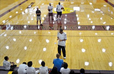 Before they hit the court, Otis Birdsong tells clinic participants to “be focused, be serious and have fun.” Richardson stands in the back, right.