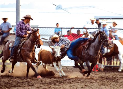 Otys Little Moustache  bails off of his horse during  the steer wrestling event. 