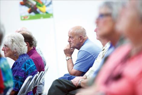 Community members  listen intently to  discussion of a  proposed resort tax that would help fund road maintenance  in Polson.