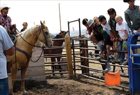 Zanen Pitts, left, teaches his roping camp students how a barrier works.