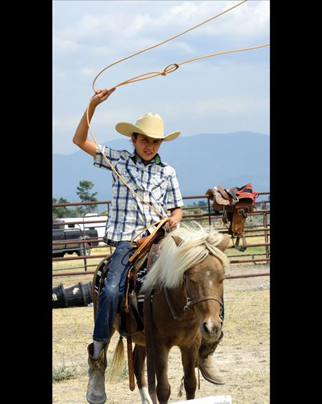 Sage Nicolai swings a loop on a patient pony.