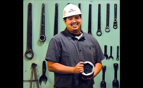 Hydro operator Clifford “Junior” Flamm displays a large socket used in Kerr Dam  maintenance and operation. 