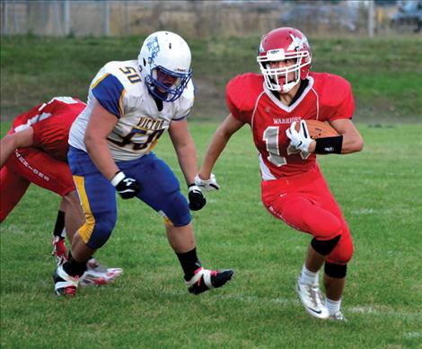 Phil Malatare avoids a Victor defender during the Western C matchup Aug. 31 in Arlee. The game was rescheduled due to smoke in the air Aug. 28.