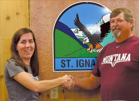 Mary Leishman is congratulated by Mayor Charley Gariepy on her position as the new clerk for the town of St. Ignatius.