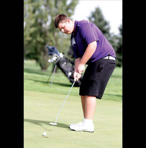 Carson McDaniel sinks a putt on the 18th hole at Polson Bay Golf Course during the Polson Invitational last week. McDaniel won the tournament, just three strokes over par.