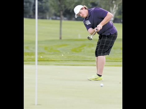 Senior Curtis Capdeville takes a putt during the Polson Invitational.