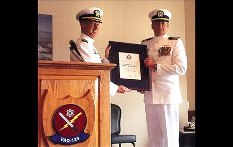 Lieutenant Commander Douglas D. Wyman, right, receives congratulations at his retirment ceremony at the Naval Air Station on Whidbey Island, Washington. 
