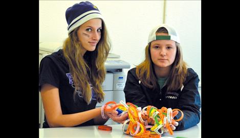 Hailey Schippers and Aubrey DuMont hold the Your Life Matters bracelets. 