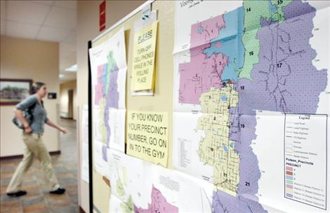 A young voter passes a precinct map on her way to vote in Polson on Election Day.