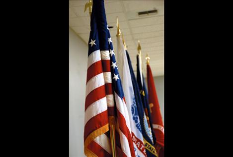 The U.S. flag and flags of the Flathead Nation, POW/MIA, Montana and other provide a backdrop for the Veterans Day dinner.