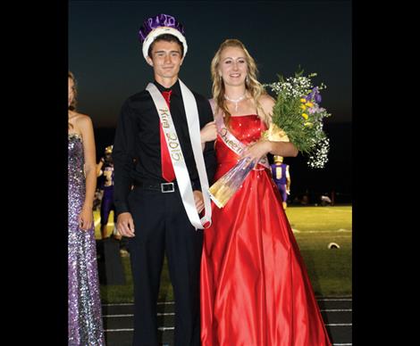 Homecoming King Jaben Wenzel and Queen Erin Sampson pose for photos after the crowning during half time at Friday’s game.