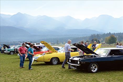 Gene and Julie Conrad and others inspect the Viewer’s Choice winner, Milt Nickel’s Plymouth Super Bird.