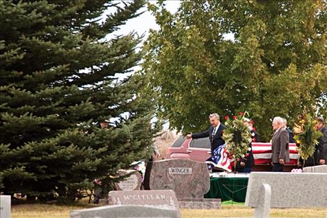 The coffin carrying Justice Jean Turnage is carried to his final resting place.