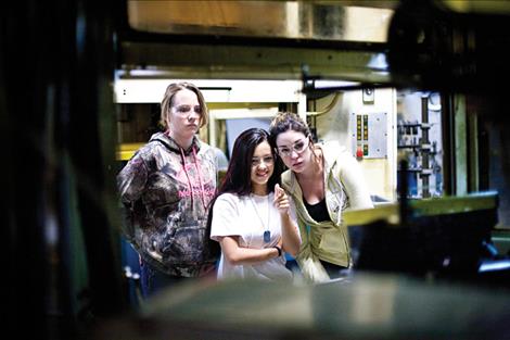 Ronan students Taylor Tobol, Teagan Gray and Katie Westberry, from left, tour Rocky Mountain Twist/Jore on Friday in recognition of Manufactoring Day.